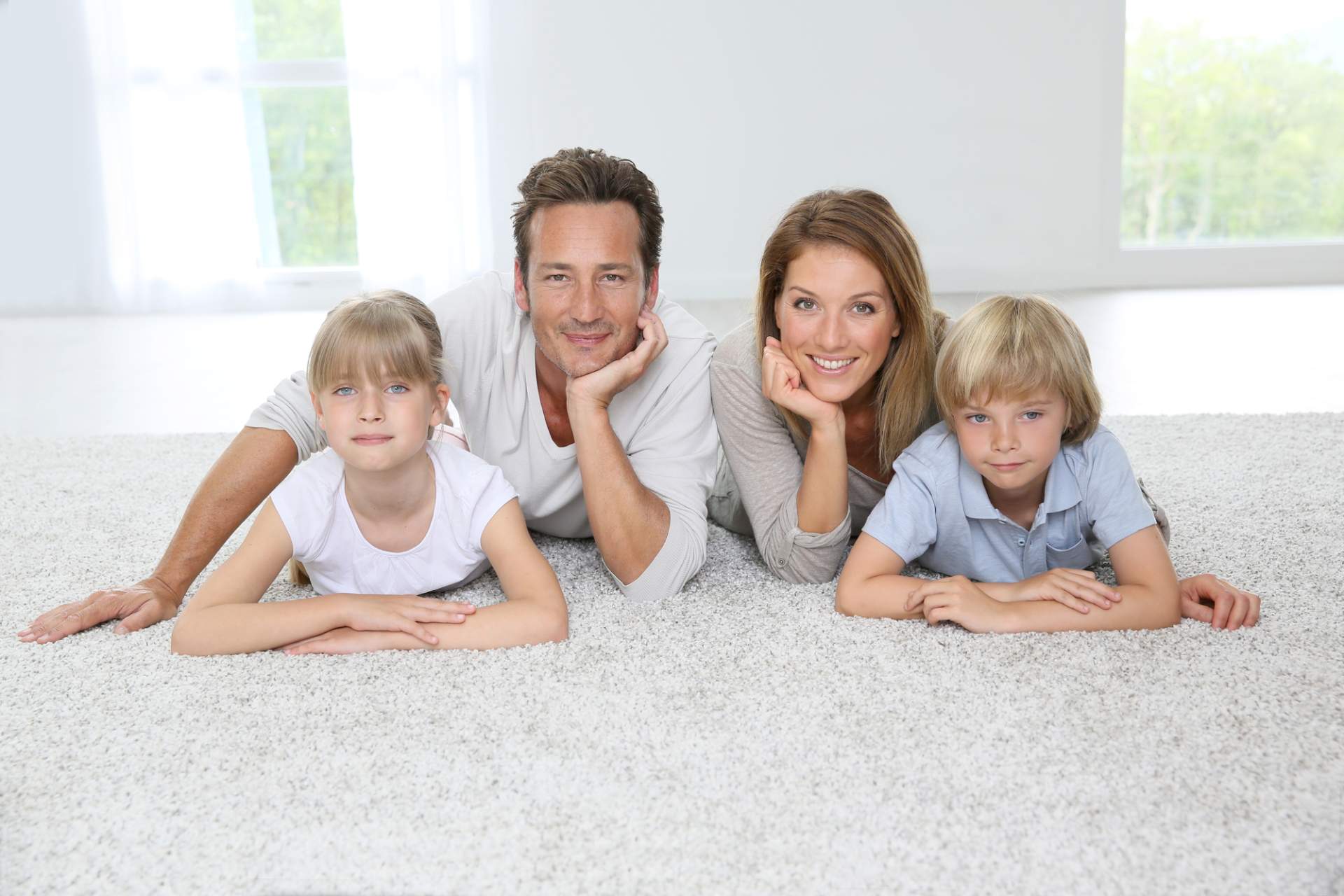 Family laying on clean carpet